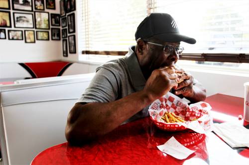 2019 08 05T175608Z_384246968_MT1USATODAY13155837_RTRMADP_3_GARLAND ADAMS TAKES A BITE OF A BURGER AT RED S GIANT