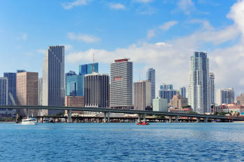 miami skyscrapers with bridge over sea in the day