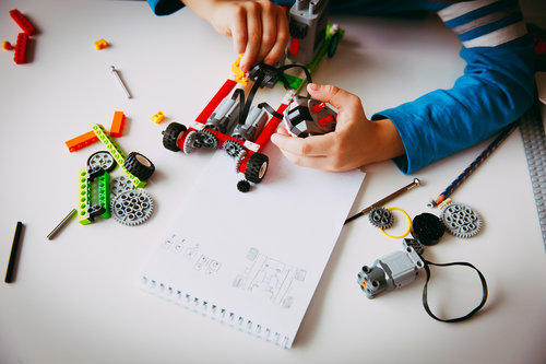 bigstock Little Boy Building Robot At R 227697319